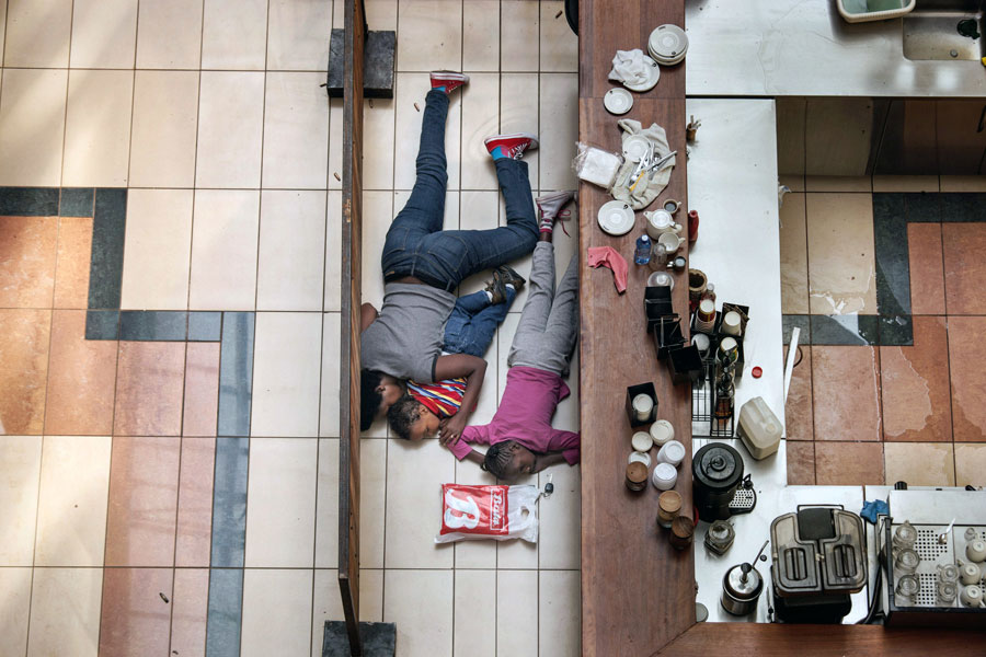 A woman tried to shelter children from gunfire by Somali militants at the Westgate mall in Nairobi, Kenya, in an attack that killed more than 70 people. Tyler Hicks made this photo from a floor above, in an exposed area where the police feared for his safety. (Tyler Hicks, The New York Times - September 23, 2013)