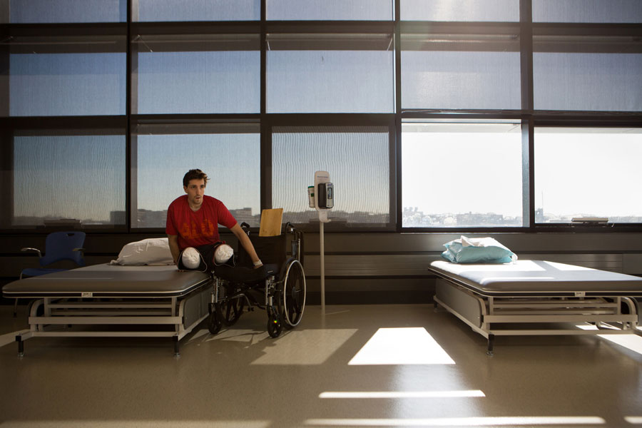 With his strength and balance improving, Bauman no longer needed a slide board (in back of his wheelchair) to move from the chair to his therapy mat at Spaulding Rehabilitation Hospital in Boston. (Josh Haner, The New York Times - May 7, 2013)