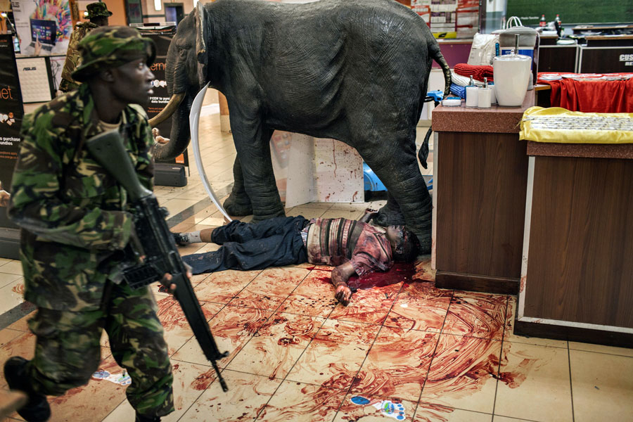 A victim lay at the feet of the statue of an elephant that was the mall's mascot. Hicks managed only a few pictures before being hurried away by the police. (Tyler Hicks, The New York Times - September 21, 2013)