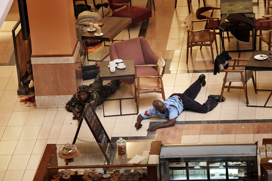 In a hastily abandoned cafe, soldiers and security officers tried to isolate the attackers and herd civilians to safety. They found many bodies in stores. (Tyler Hicks, The New York Times - September 21, 2013)