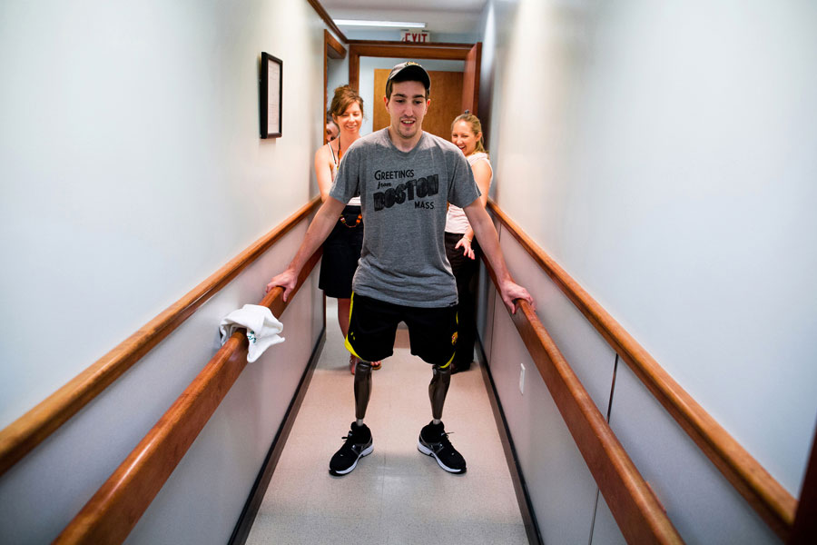 At a final fitting for his prosthetic legs, Bauman walked on his own for the first time since the day of the marathon. His girlfriend Erin, looked at him and said, 'I love that you're standing right now,' before coming around to steady him and kiss him. (Josh Haner, The New York Times - May 31, 2013)