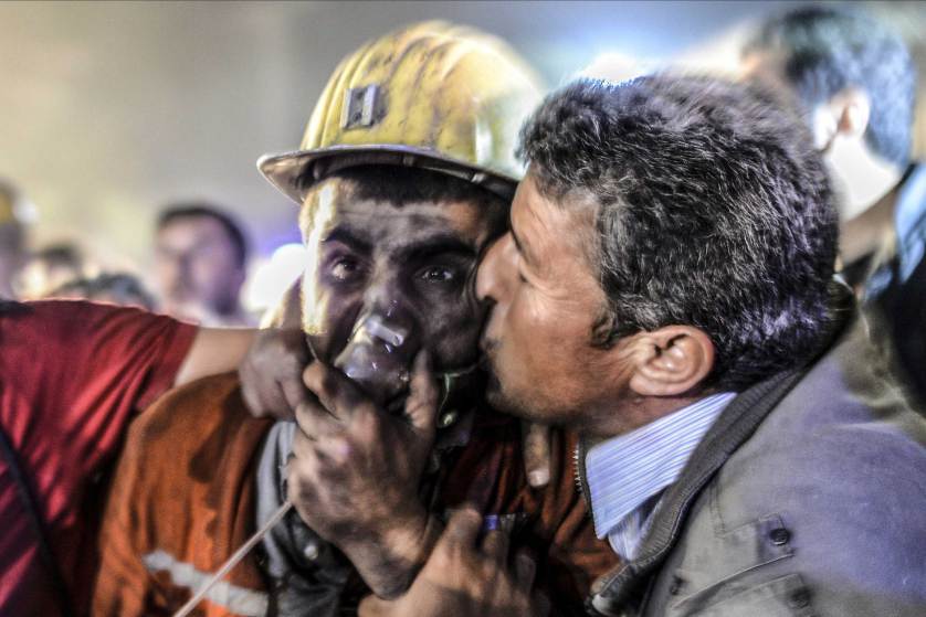 A man kisses his son, rescued of the mine, on May 13, 2014 after an explosion in a coal mine in Manisa. At least 157 miners were killed in collapsed coal mine in the western Turkish city of Manisa. "At least 200-300 workers were working in the mine when an electric fault caused an explosion," the mayor of Soma, a district of Manisa, told private NTV television. AFP PHOTO/BULENT KILICBULENT KILIC/AFP/Getty Images