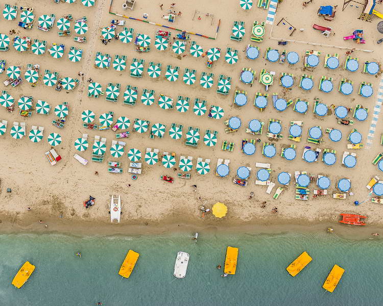 The colourful umbrellas create amazing geometric patterns which contrast dramatically with the golden sand and azure-coloured sea. From the air it is possible to see how almost every inch of sand is used on a busy summer's day on the Adriatic coastline.