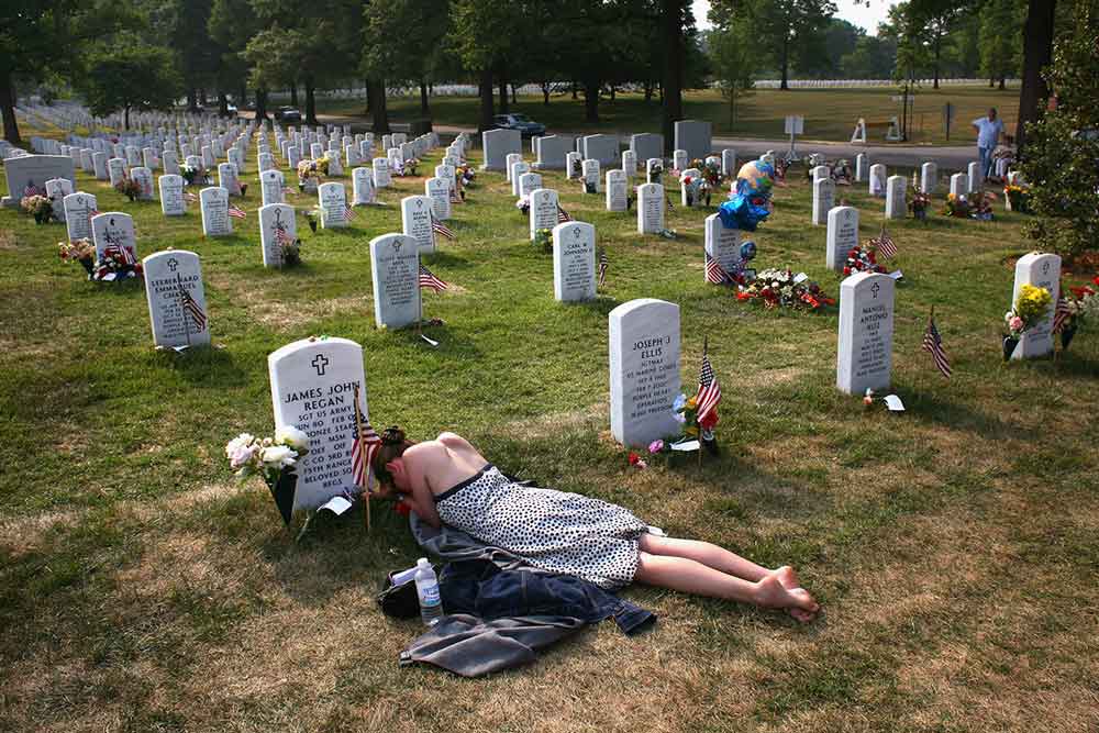 John-Moore-woman-weeping-husbands-grave_tcm80-1294707