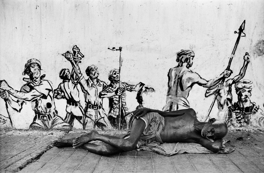 Man-asleep-in-front-of-political-graffiti,-Calcutta,-c.-1978-web