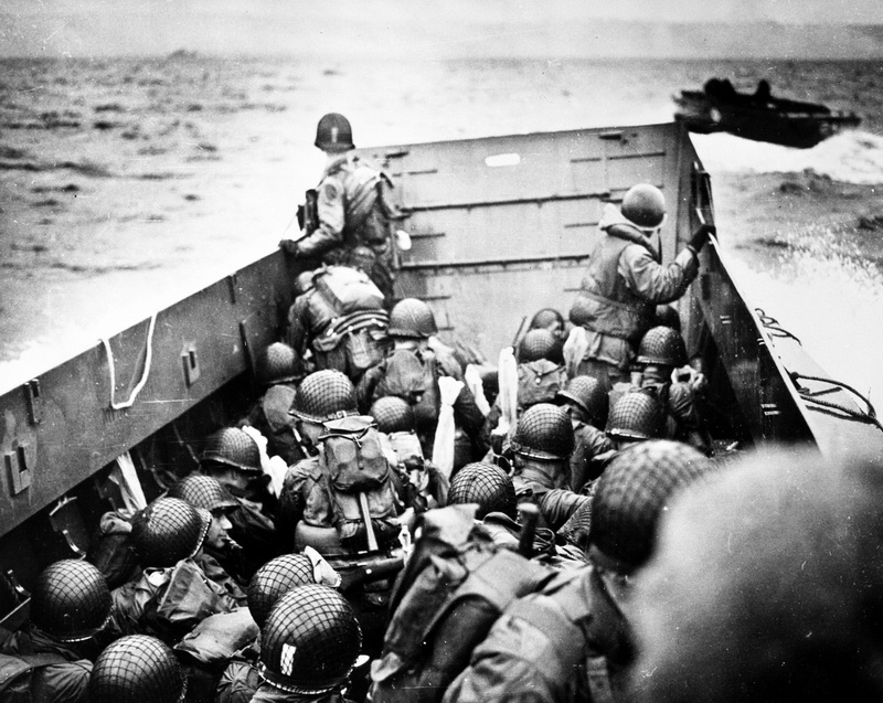 “Troops crouch inside a LCVP landing craft, just before landing on Omaha Beach on D-Day”. 6 June, 1944 Omaha Beach, Normandy, France  Photographer: unknown or not provided Courtesy U.S. Coast Guard Collection / U.S. National Archives 