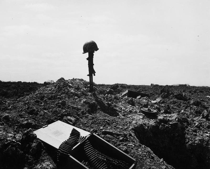 “The beachhead is secure, but the price was high. A Coast Guard Combat photographer came upon this monument to a dead American soldier somewhere on the shell-blasted shore of Normandy”.  June 1944 Normandy, France Photographer: unknown or not provided Courtesy U.S. National Archives 